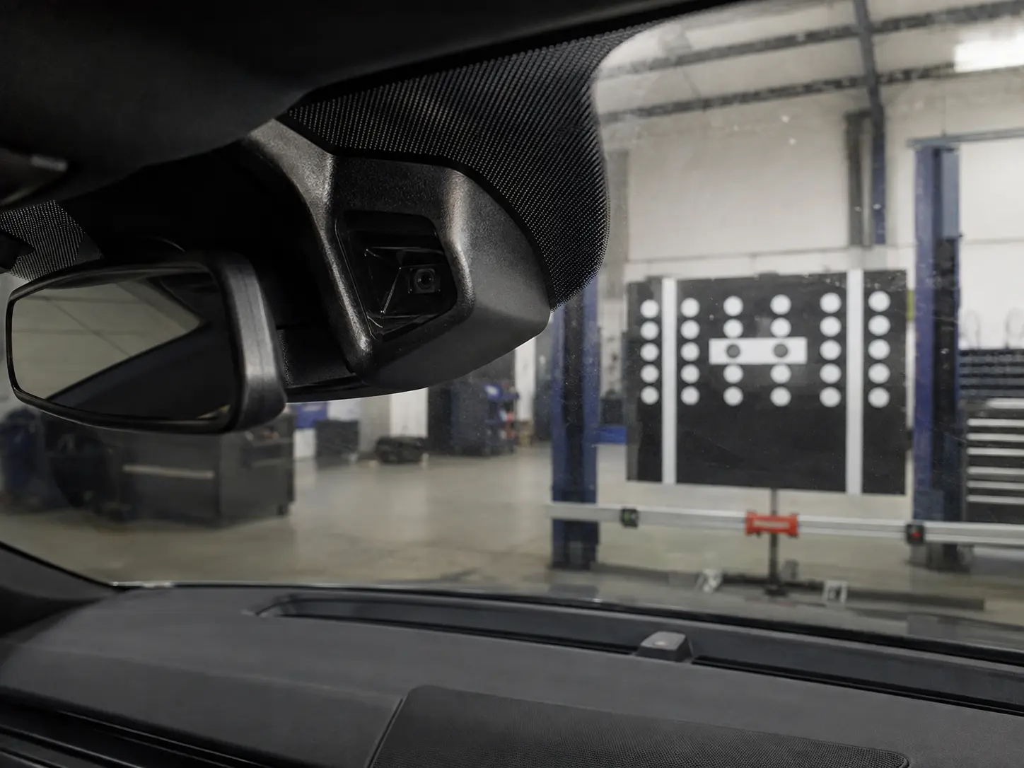 ADAS calibration target and modern vehicle in a workshop